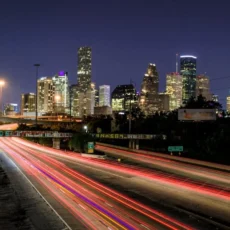 time lapse photography of vehicle traveling with a speed of light in road